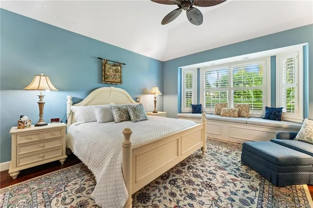 a bathroom with a granite countertop shower a sink and a mirror