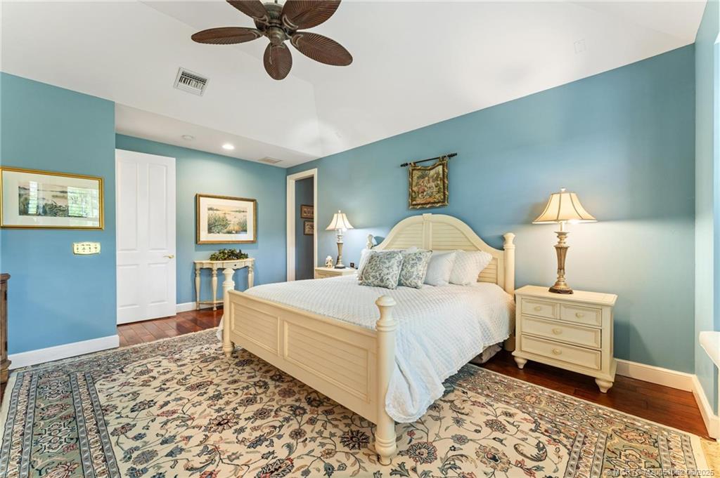 3192 Southeast Fairway West Stuart, FL 34997 - Photo 31 of 76 a bedroom with a bed and wooden floor