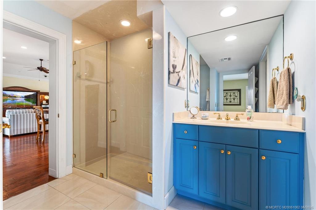 3192 Southeast Fairway West Stuart, FL 34997 - Photo 36 of 76 a bathroom with a shower sink and mirror