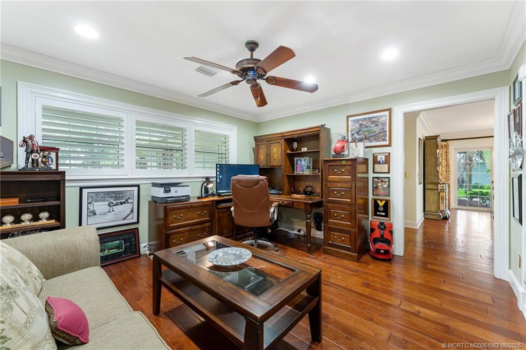 3192 Southeast Fairway West Stuart, FL 34997 - Photo 38 of 76 a living room with furniture a fireplace and a flat screen tv
