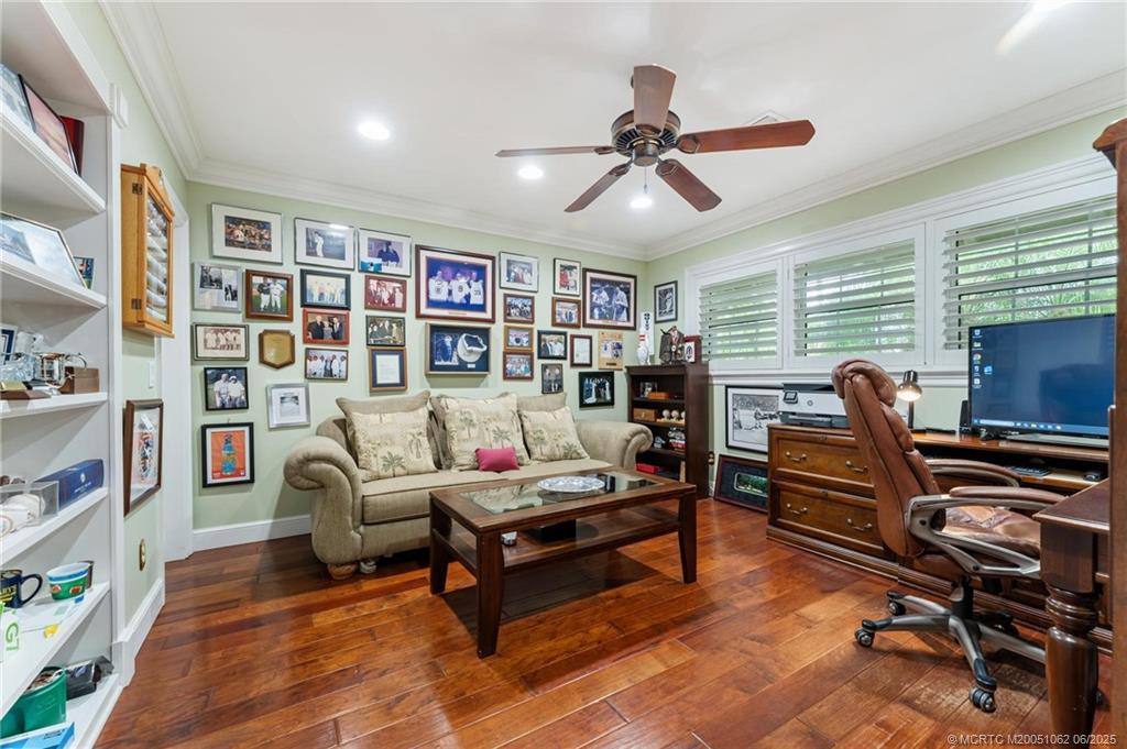 3192 Southeast Fairway West Stuart, FL 34997 - Photo 39 of 76 a living room with furniture and a bookshelf