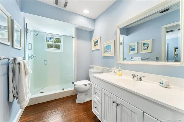 a bathroom with a sink a toilet and mirror