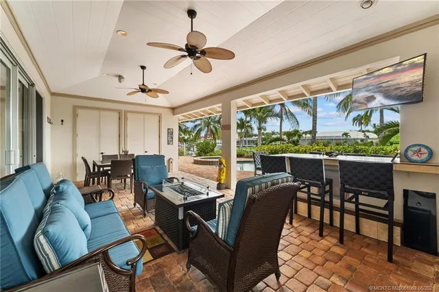 a view of a house with a yard and palm trees