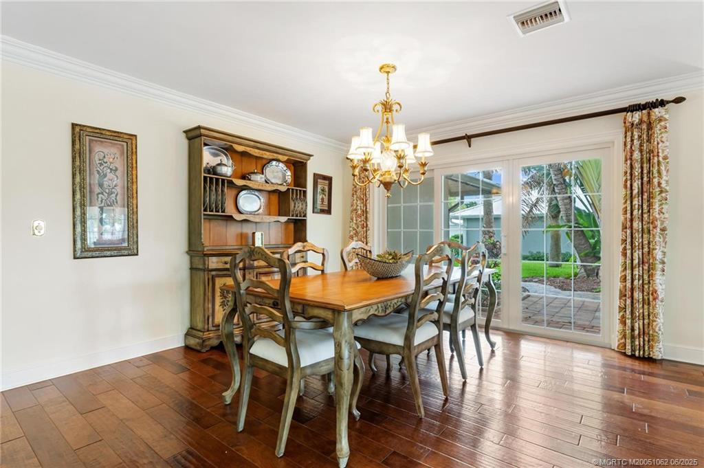 3192 Southeast Fairway West Stuart, FL 34997 - Photo 6 of 76 a view of a dining room with furniture wooden floor and chandelier