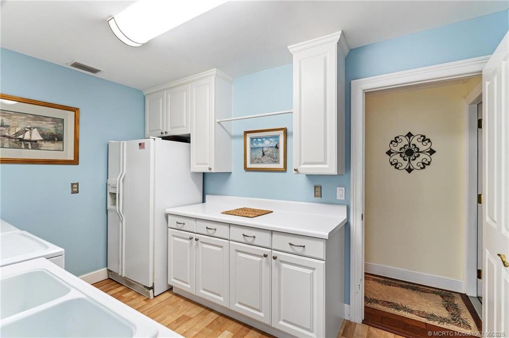 3192 Southeast Fairway West Stuart, FL 34997 - Photo 65 of 76 a kitchen with a refrigerator and a stove