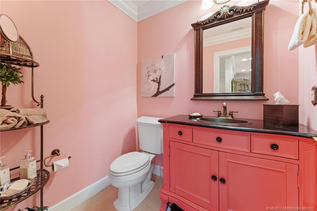 3192 Southeast Fairway West Stuart, FL 34997 - Photo 66 of 76 a bathroom with a sink a toilet and mirror