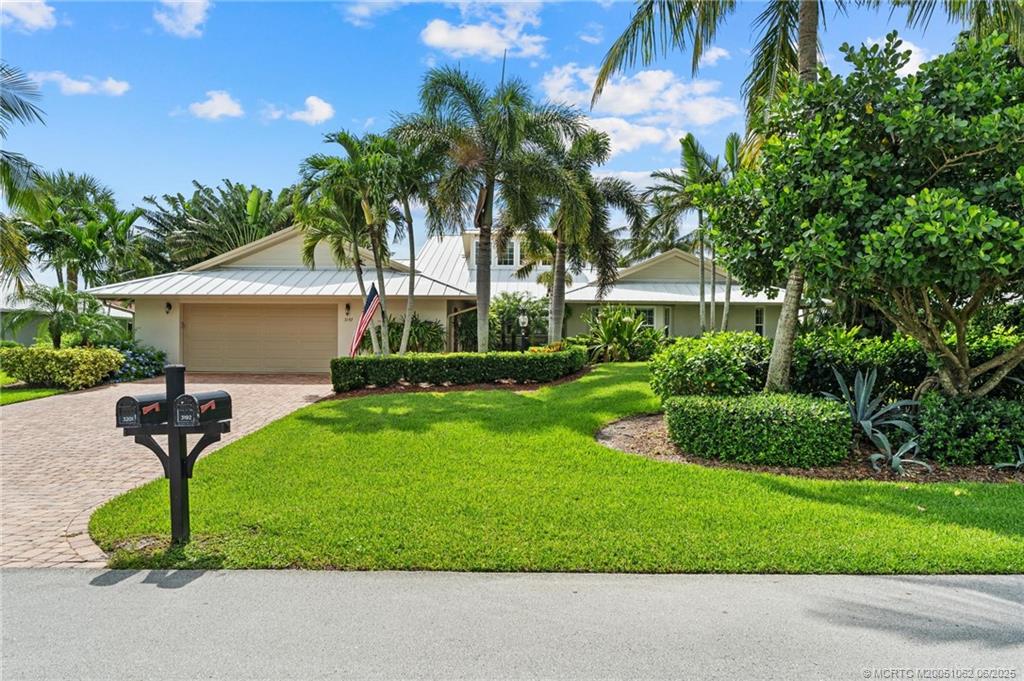 3192 Southeast Fairway West Stuart, FL 34997 - Photo 74 of 76 a front view of a house with a garden and yard