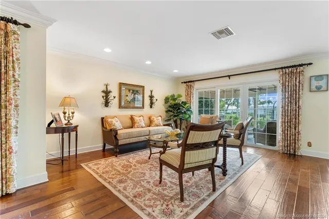 a living room with furniture a clock and a rug