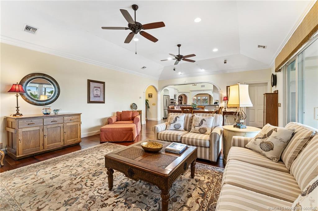 3192 Southeast Fairway West Stuart, FL 34997 - Photo 9 of 76 a living room with furniture a clock and a rug