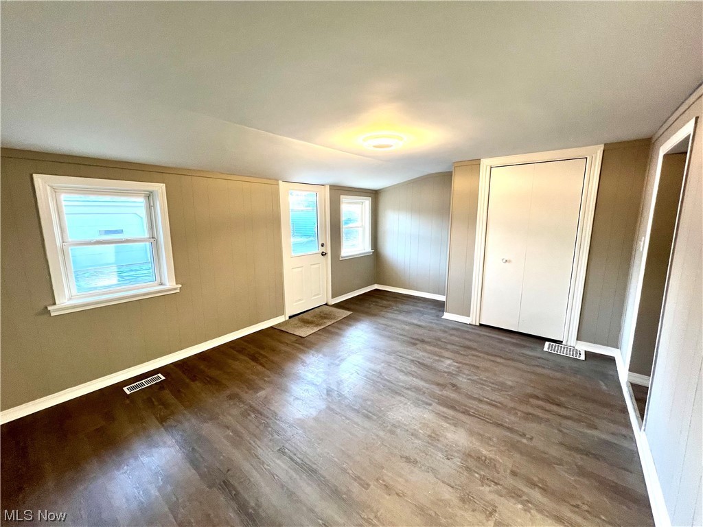 3527 Broadview Road Cleveland, OH 44109 - Photo 4 of 29 Unfurnished bedroom with dark wood-type flooring, multiple windows, and a closet