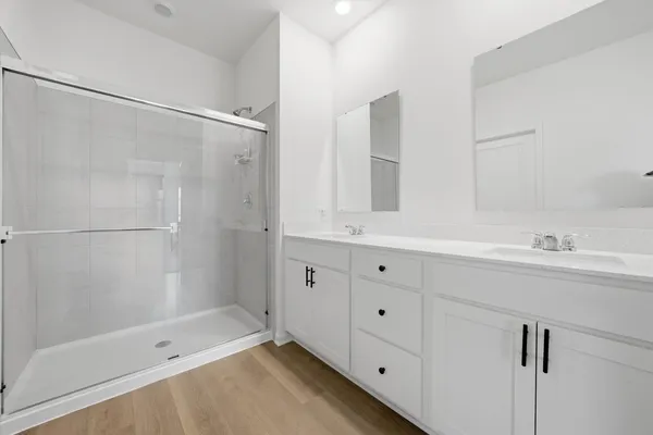 a bathroom with a shower sink and mirror
