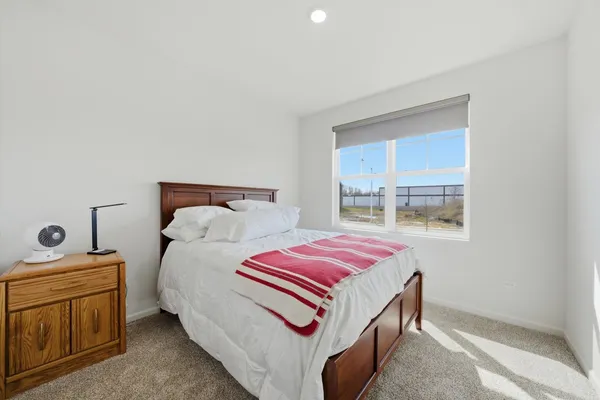 a bedroom with a bed and window