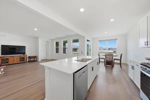 a kitchen with stainless steel appliances granite countertop a stove and a sink