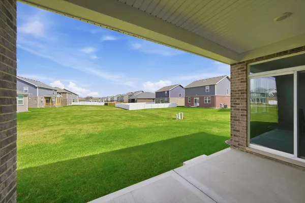 a view of a house with a yard porch and sitting area