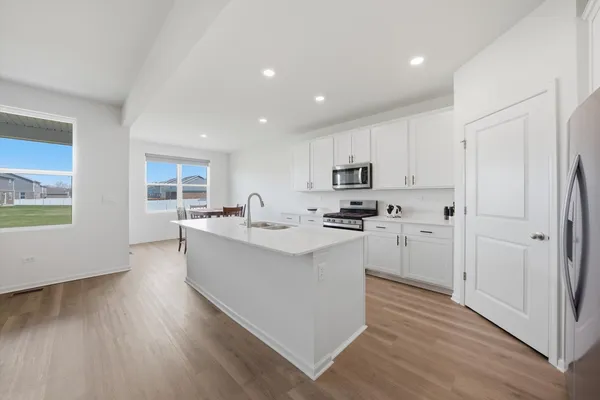 a kitchen with cabinets and wooden floor