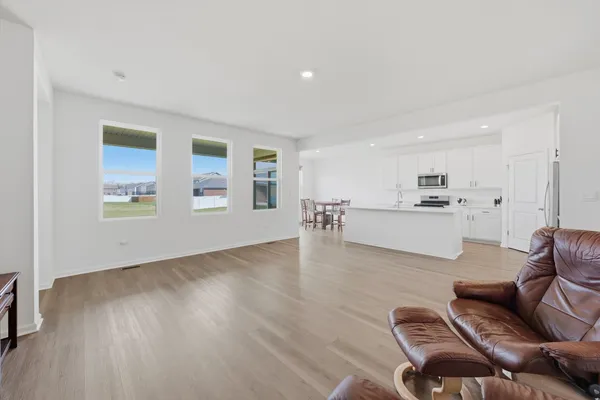 a living room with furniture and kitchen view