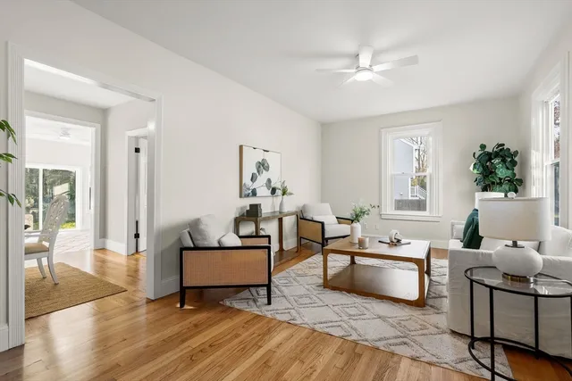 a living room with furniture and a wooden floor
