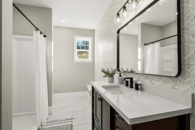 a bathroom with a sink and a mirror