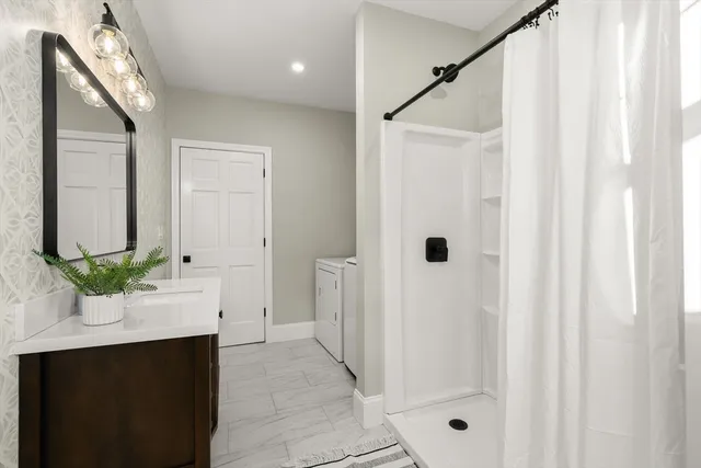 a bathroom with a double vanity sink and shower