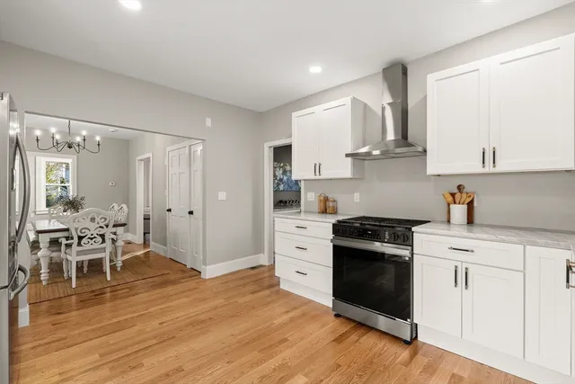 a kitchen with white cabinets and appliances