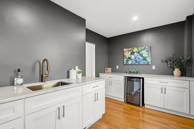 a kitchen with sink and white cabinets