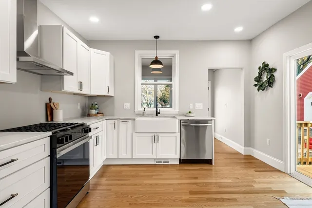 a kitchen with stainless steel appliances a white stove top oven and sink