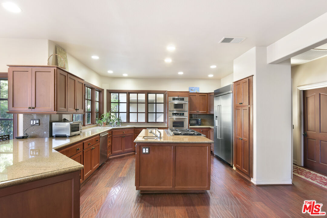 480 Westlake Boulevard Malibu, CA 90265 - Photo 12 of 36 a kitchen with stainless steel appliances granite countertop a sink a stove and a refrigerator