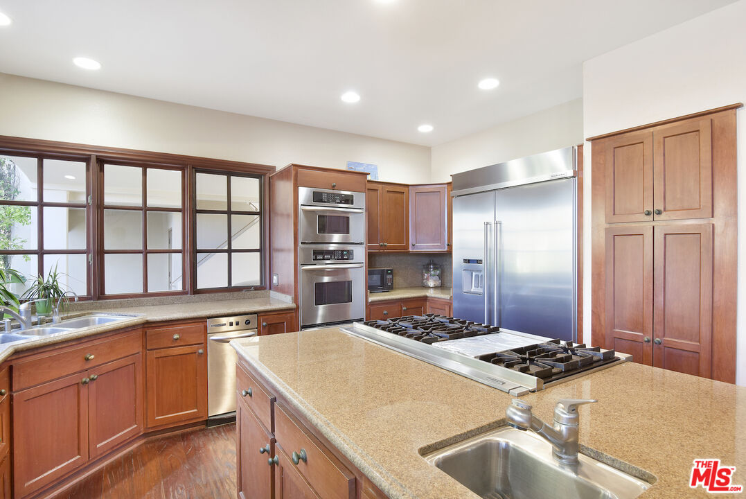 480 Westlake Boulevard Malibu, CA 90265 - Photo 14 of 36 a kitchen with a stove a sink and a refrigerator