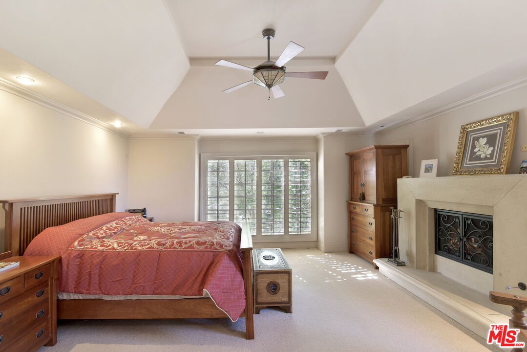 480 Westlake Boulevard Malibu, CA 90265 - Photo 17 of 36 a bedroom with a bed and a fireplace