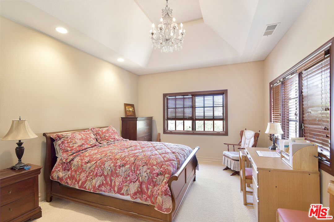 480 Westlake Boulevard Malibu, CA 90265 - Photo 22 of 36 a spacious bedroom with a bed and wooden floor
