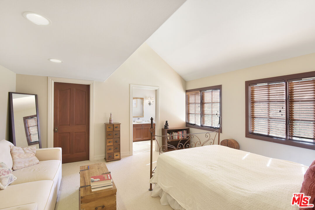 480 Westlake Boulevard Malibu, CA 90265 - Photo 24 of 36 a large bedroom with a large bed and glass windows