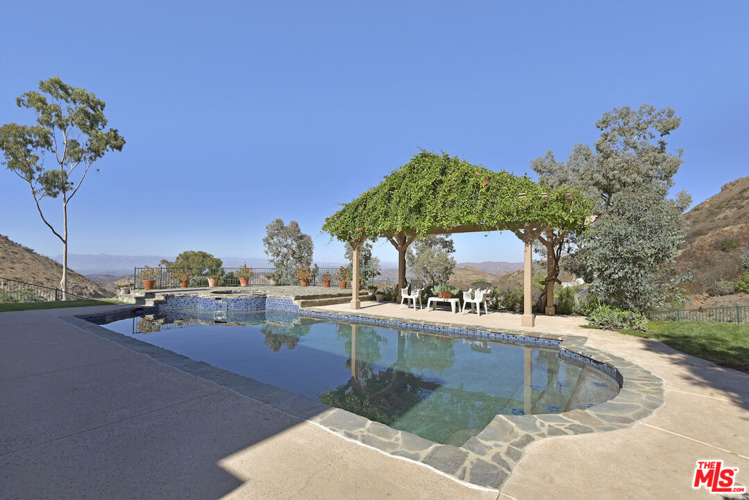 480 Westlake Boulevard Malibu, CA 90265 - Photo 28 of 36 a view of a backyard with a patio and fire pit