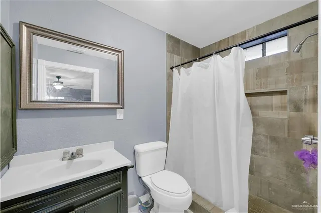 a white toilet sitting next to a bathroom sink