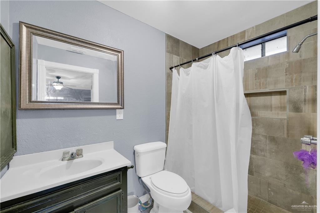 537 Benito Street Rio Grande City, TX 78582 - Photo 8 of 20 a white toilet sitting next to a bathroom sink