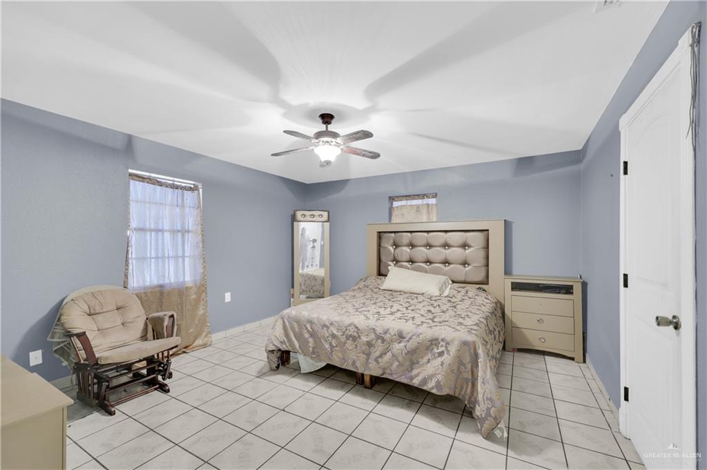 537 Benito Street Rio Grande City, TX 78582 - Photo 9 of 20 a bedroom with a bed and a chandelier