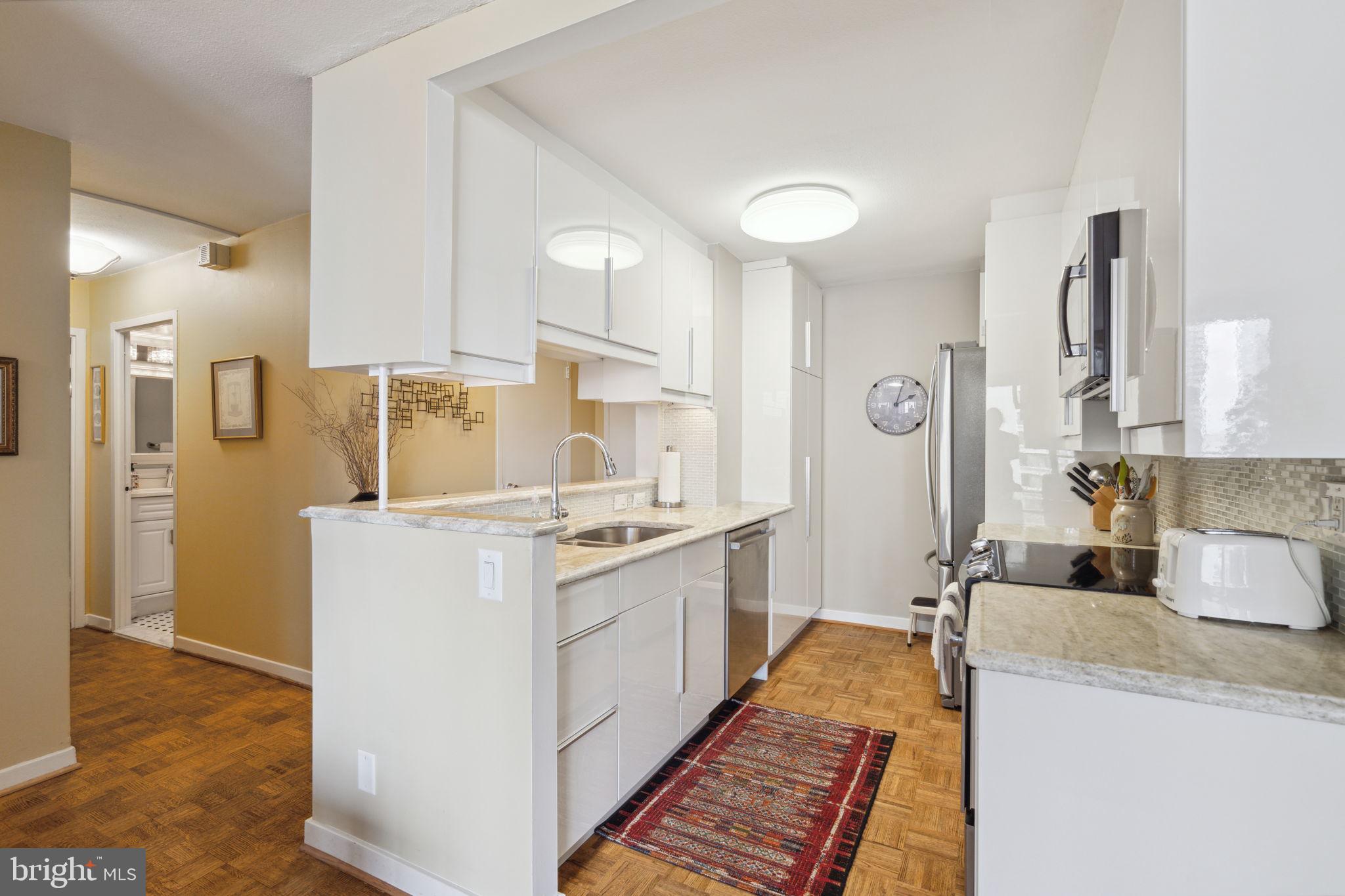 224-30 West Rittenhouse Square, Unit 1201 Philadelphia, PA 19103 - Photo 12 of 34 a kitchen with a sink stove and refrigerator