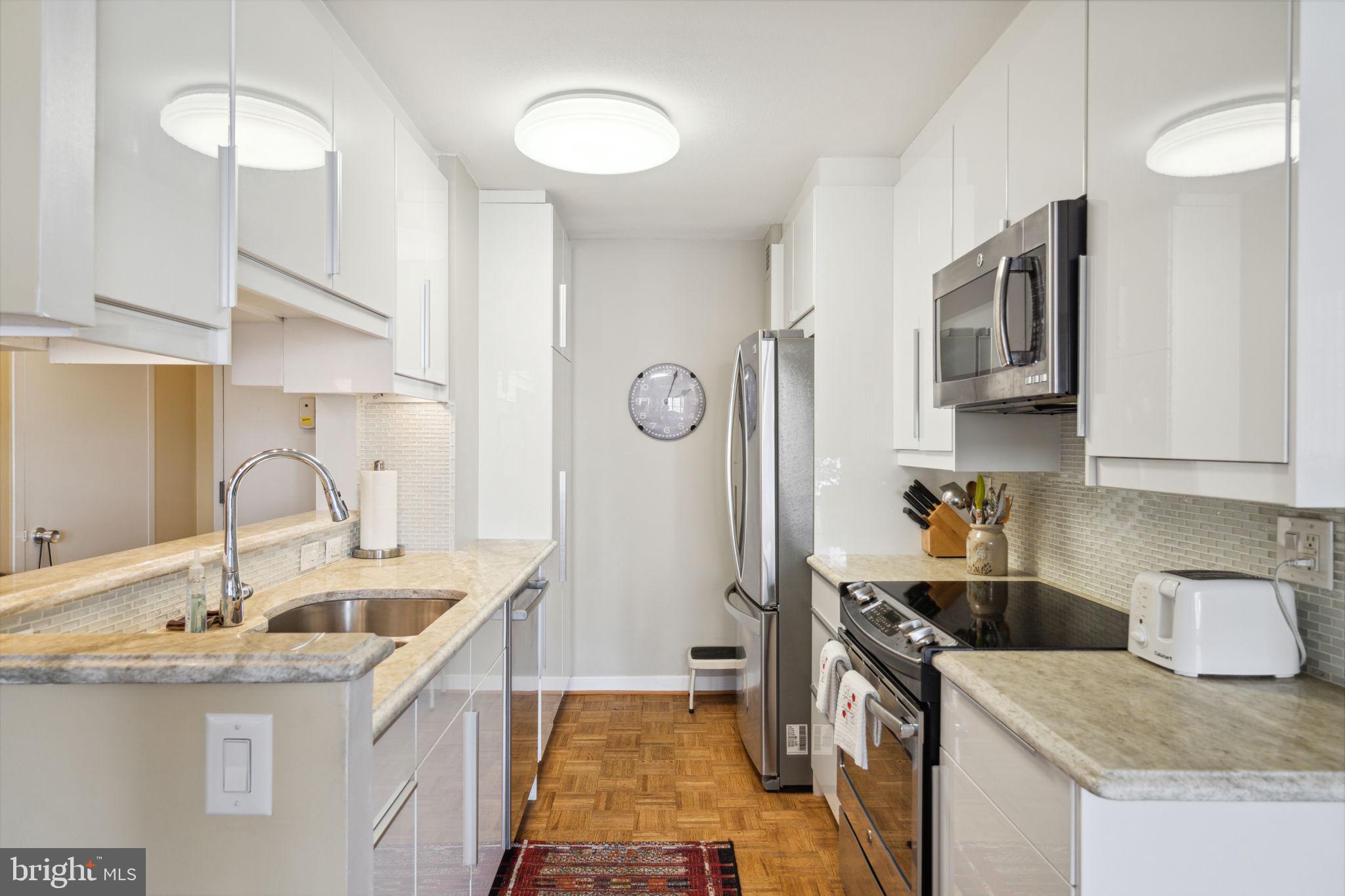 224-30 West Rittenhouse Square, Unit 1201 Philadelphia, PA 19103 - Photo 13 of 34 a kitchen that has a sink and a stove