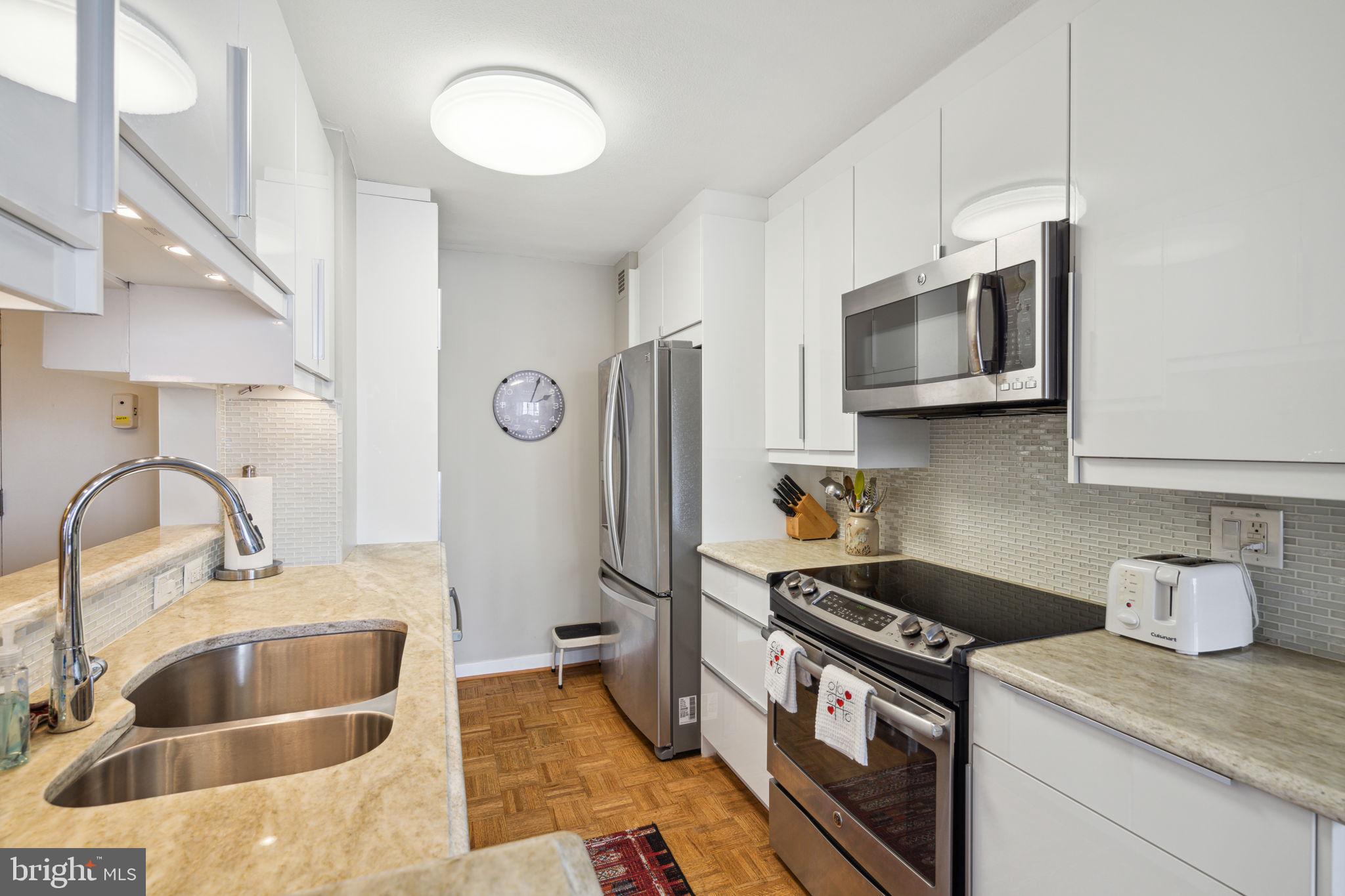 224-30 West Rittenhouse Square, Unit 1201 Philadelphia, PA 19103 - Photo 14 of 34 a kitchen with stainless steel appliances granite countertop a sink stove and refrigerator
