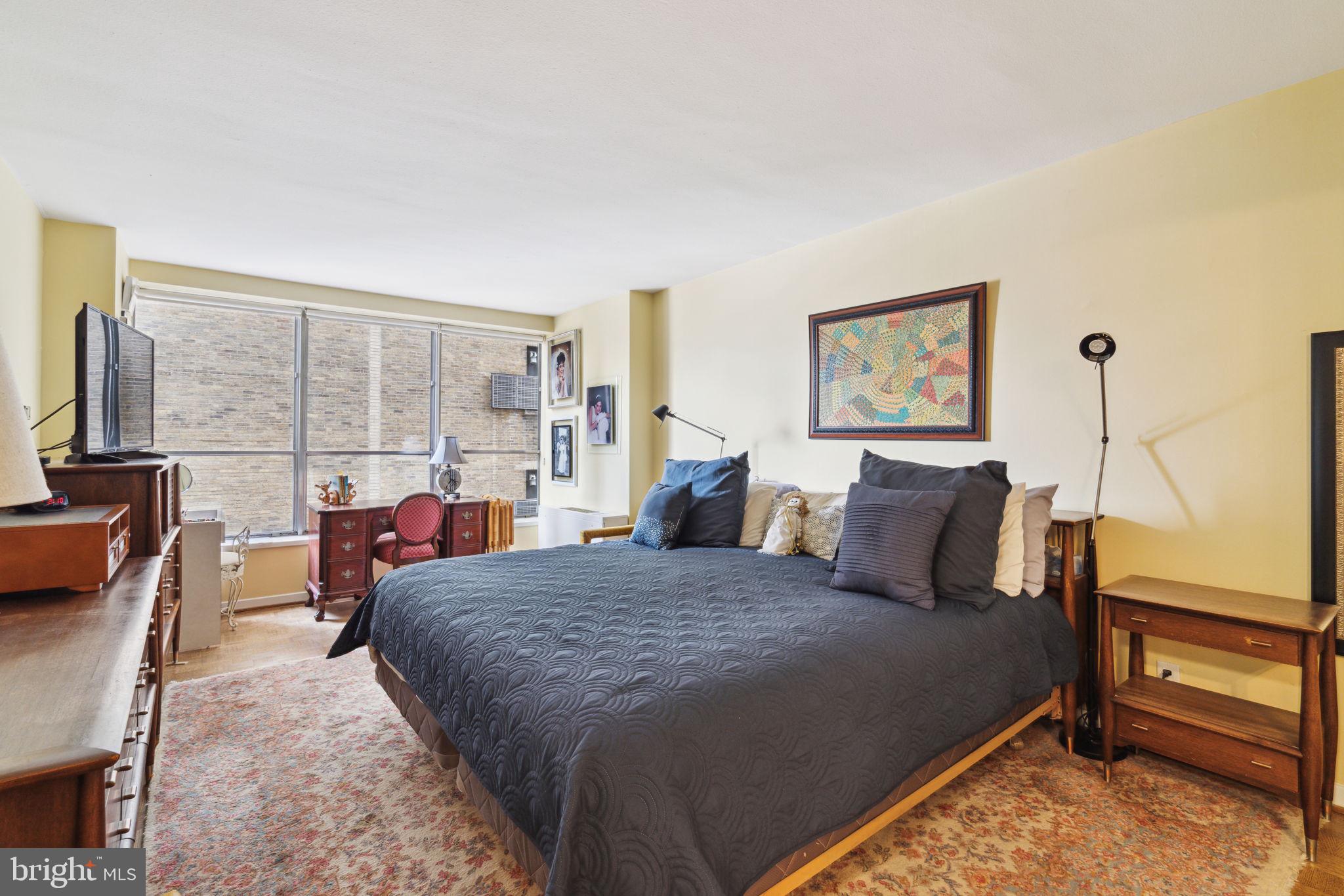224-30 West Rittenhouse Square, Unit 1201 Philadelphia, PA 19103 - Photo 16 of 34 a bed room with a bed and a table