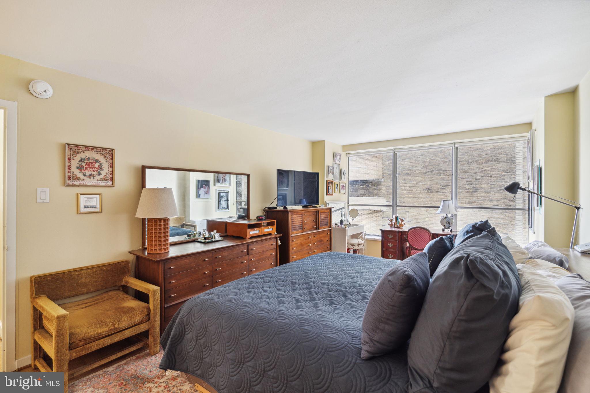 224-30 West Rittenhouse Square, Unit 1201 Philadelphia, PA 19103 - Photo 17 of 34 a living room with furniture a large window and a flat screen tv