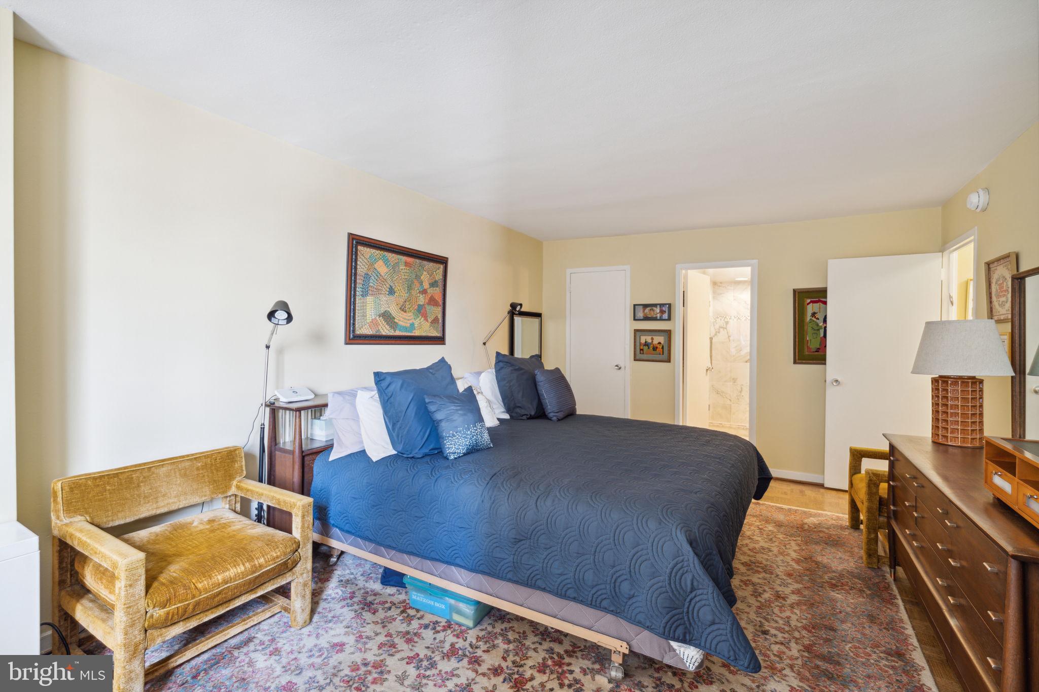 224-30 West Rittenhouse Square, Unit 1201 Philadelphia, PA 19103 - Photo 19 of 34 a bedroom with a bed and wooden floor