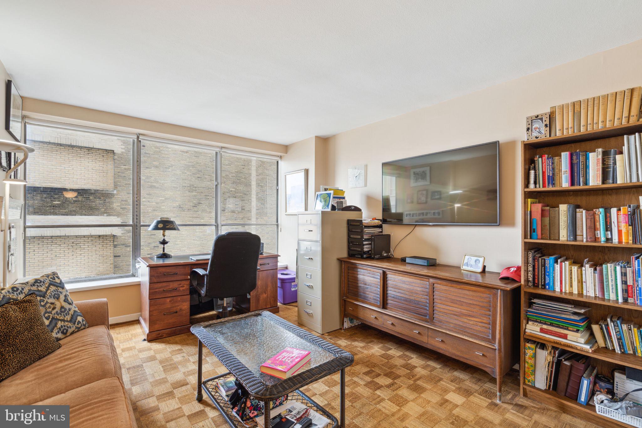 224-30 West Rittenhouse Square, Unit 1201 Philadelphia, PA 19103 - Photo 22 of 34 a workspace with furniture and a book shelf