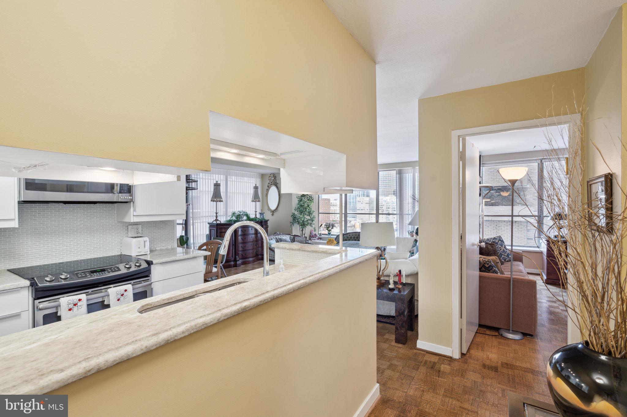 224-30 West Rittenhouse Square, Unit 1201 Philadelphia, PA 19103 - Photo 3 of 34 a kitchen with stainless steel appliances granite countertop a sink stove and refrigerator