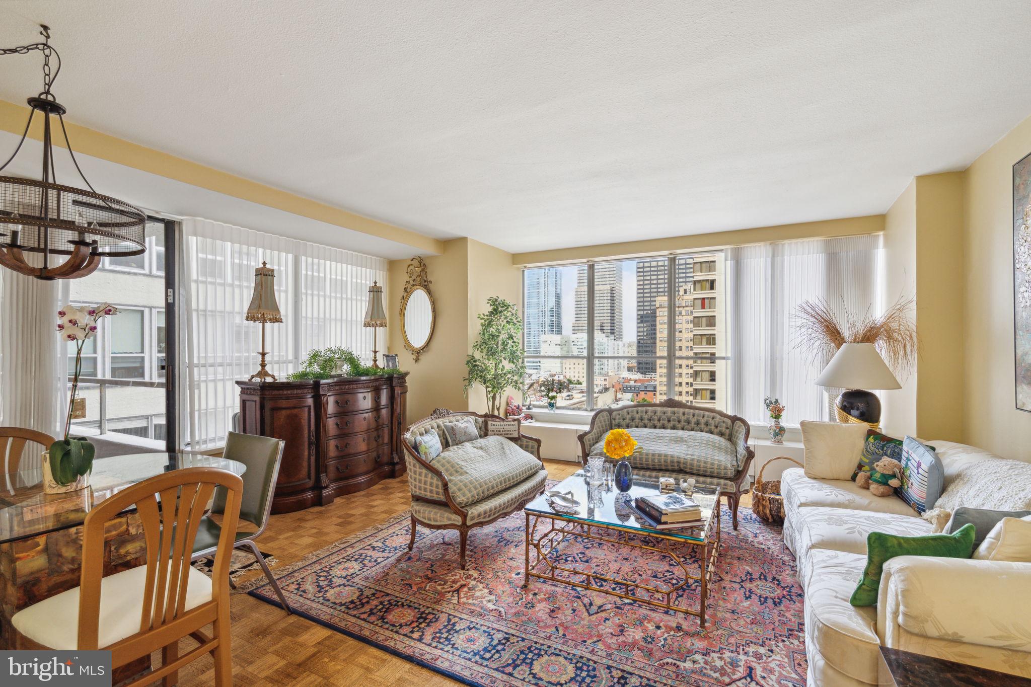 224-30 West Rittenhouse Square, Unit 1201 Philadelphia, PA 19103 - Photo 4 of 34 a living room with furniture and a large window