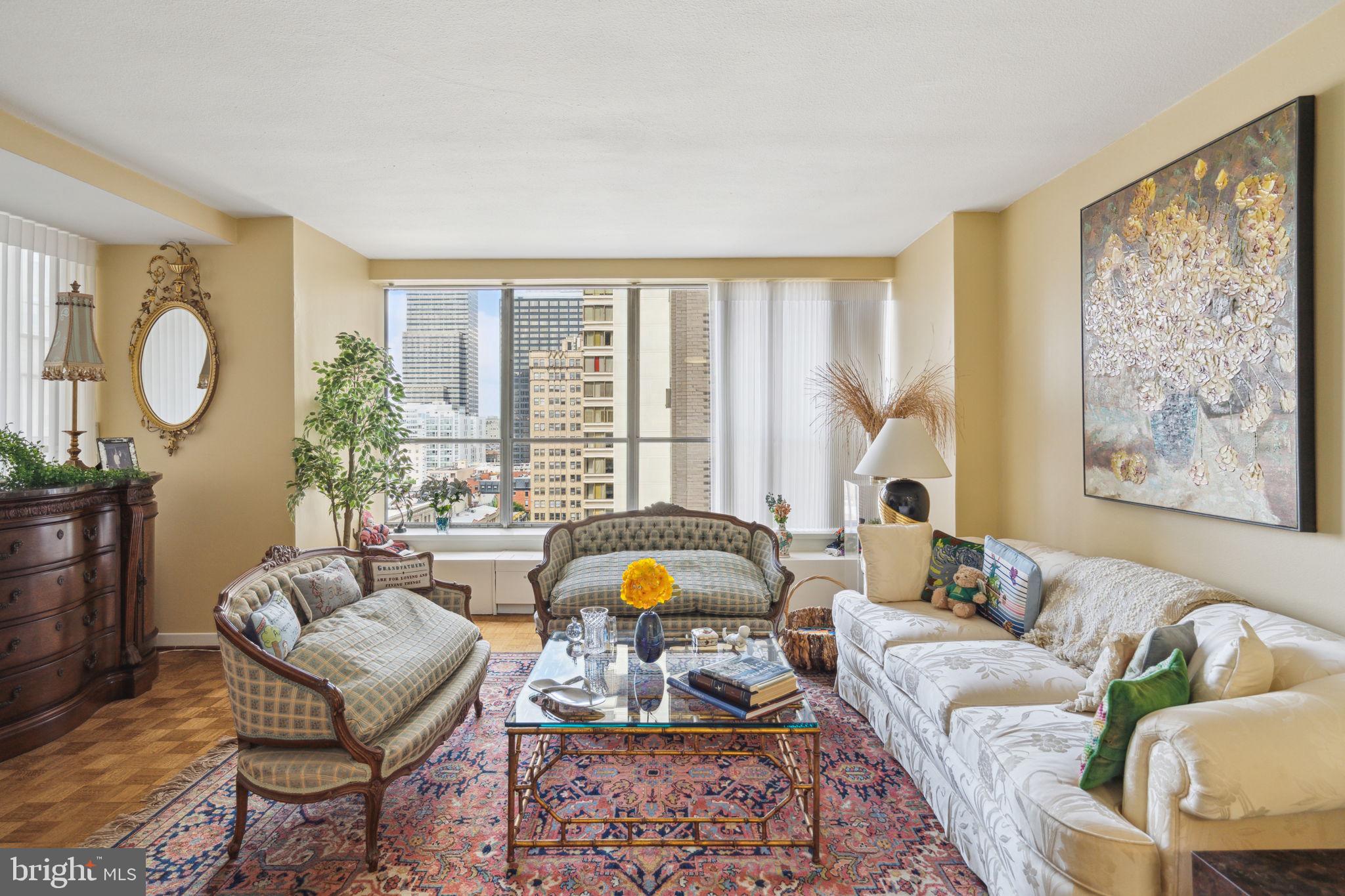224-30 West Rittenhouse Square, Unit 1201 Philadelphia, PA 19103 - Photo 5 of 34 a living room with furniture and a large window