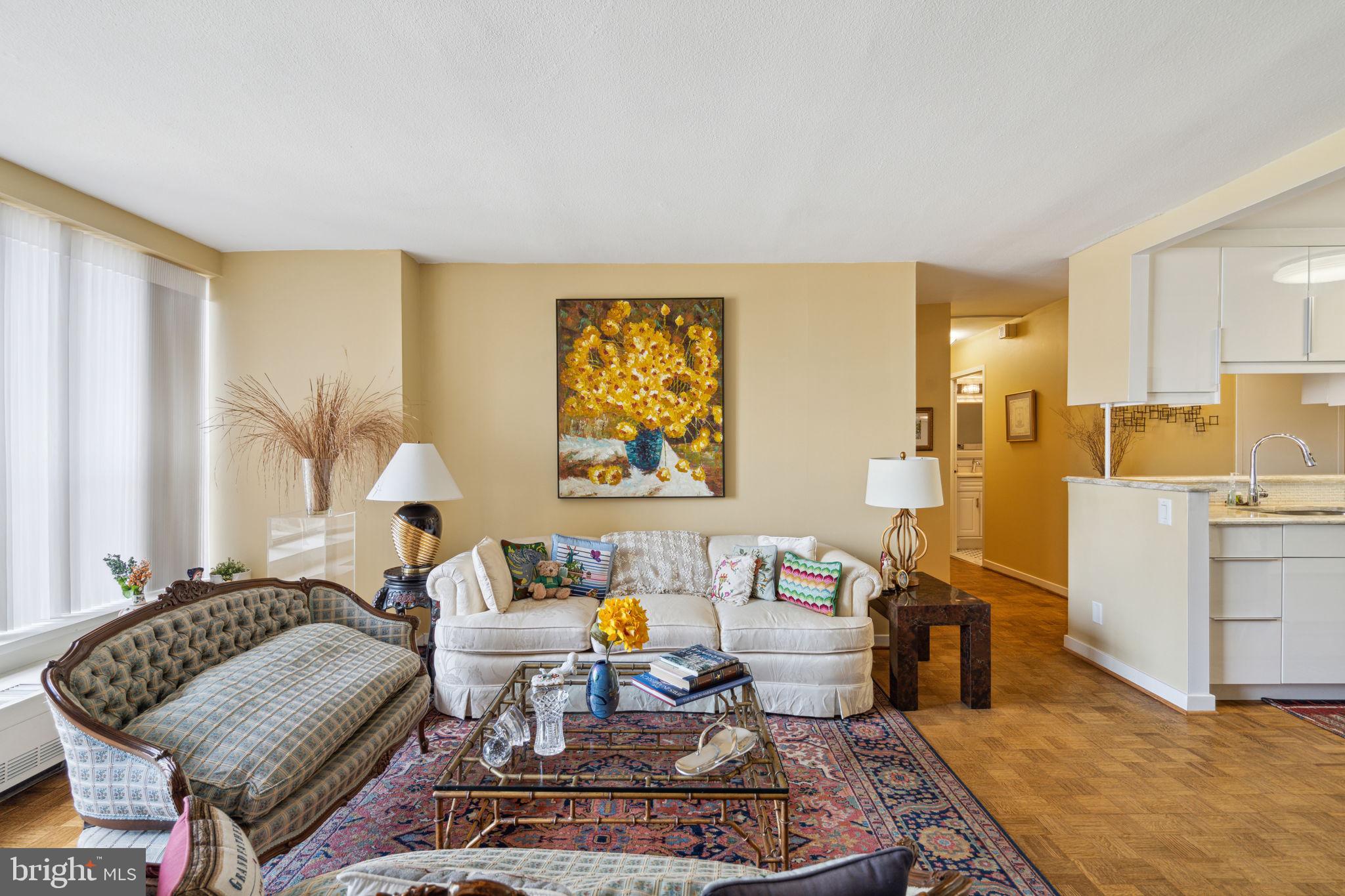 224-30 West Rittenhouse Square, Unit 1201 Philadelphia, PA 19103 - Photo 7 of 34 a living room with furniture a rug and a chandelier