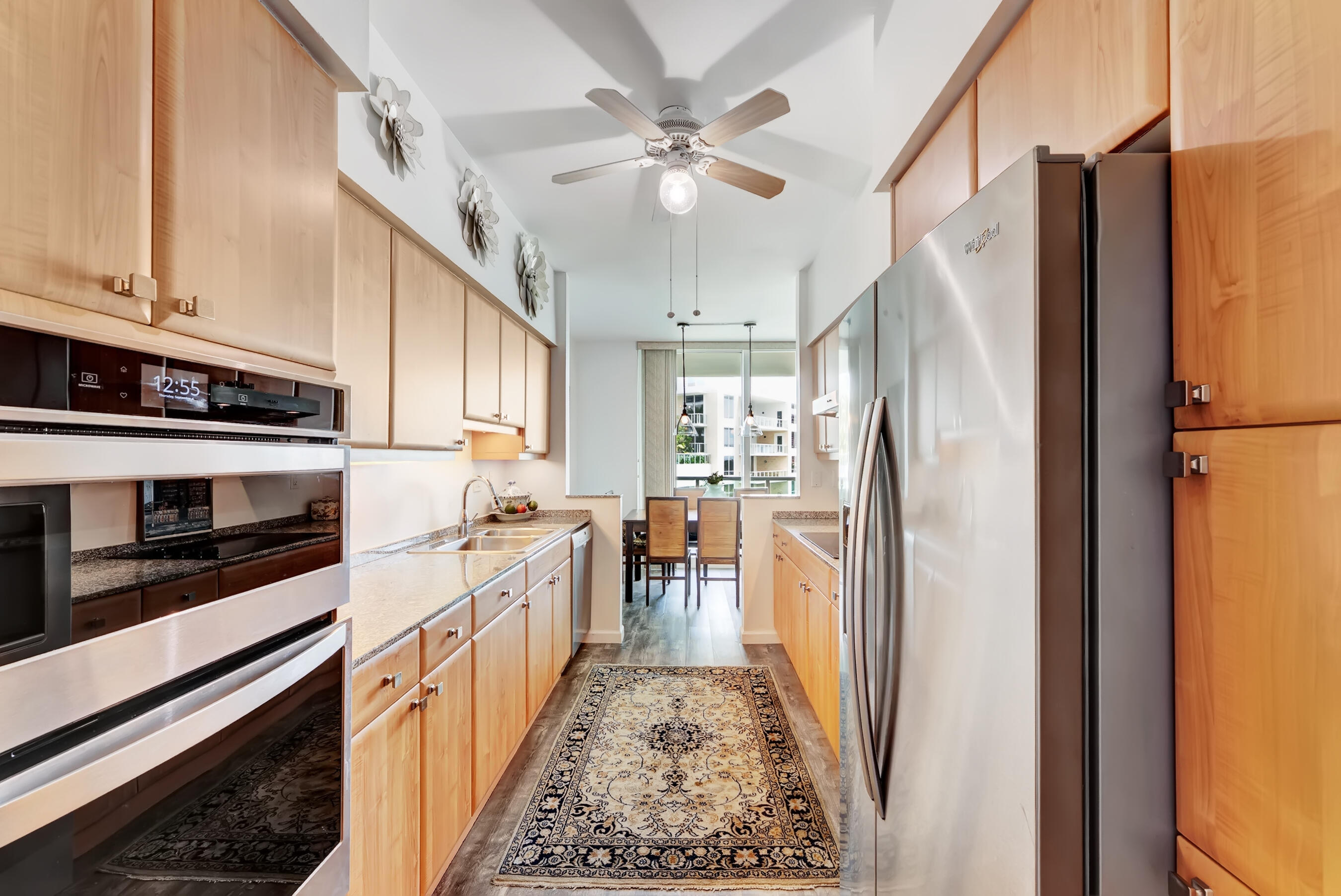500 Southeast Mizner Boulevard, Unit A710 Boca Raton, FL 33432 - Photo 25 of 50 a kitchen with stainless steel appliances granite countertop a refrigerator a stove and a sink with cabinets