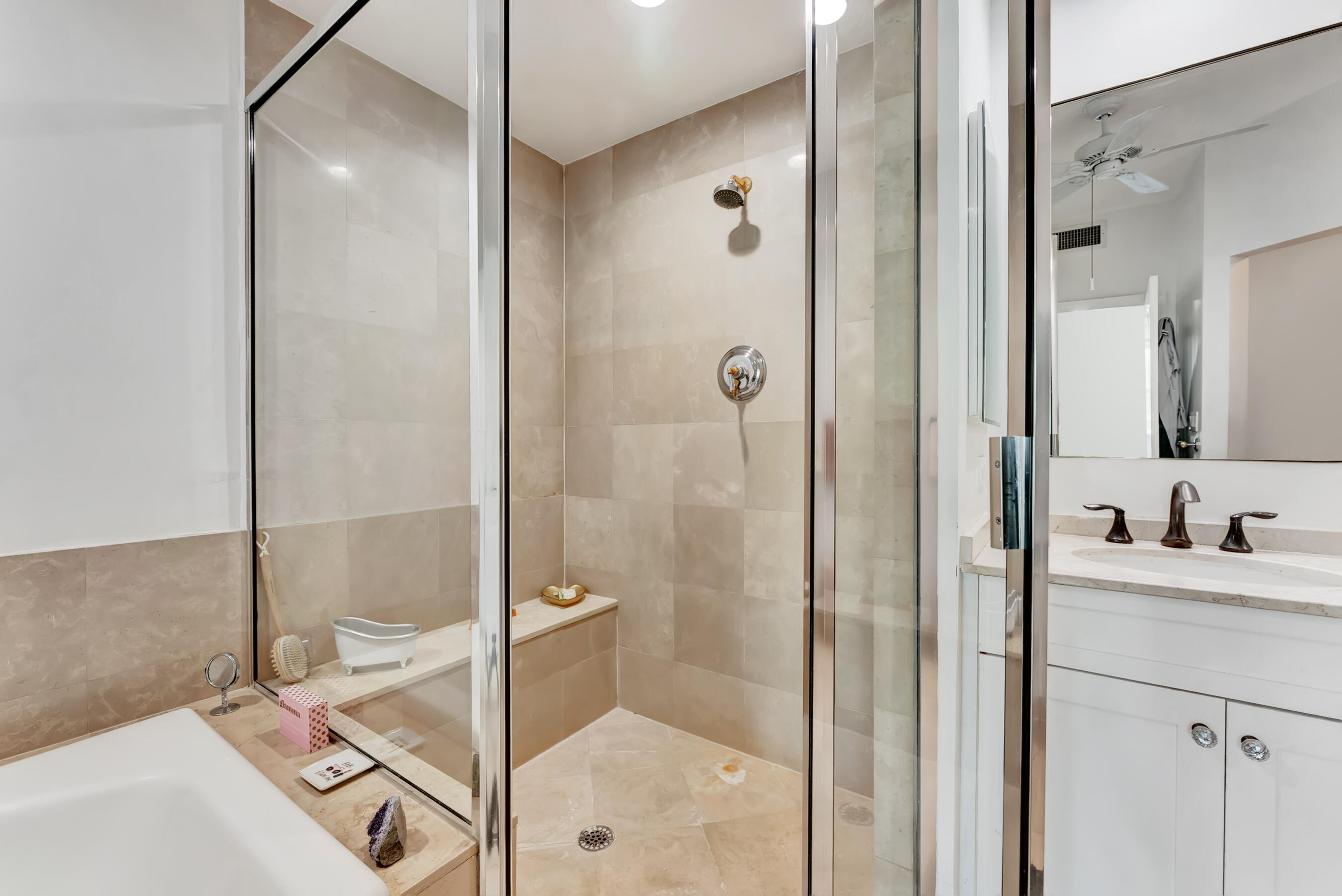 500 Southeast Mizner Boulevard, Unit A710 Boca Raton, FL 33432 - Photo 34 of 50 a bathroom with a shower sink and mirror