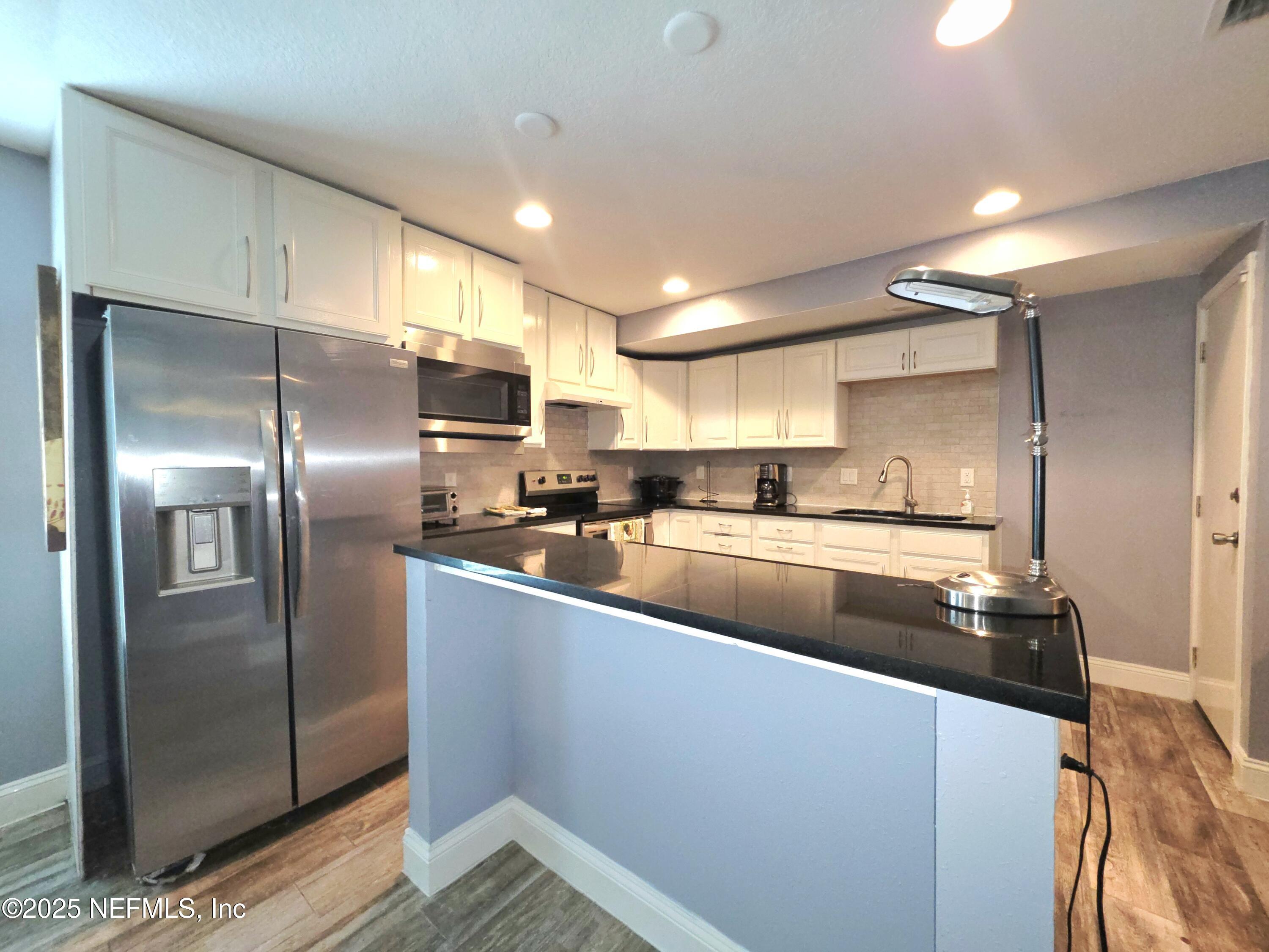 3065 Francis Road Jacksonville, FL 32209 - Photo 12 of 22 a kitchen with stainless steel appliances granite countertop a refrigerator a sink and a stove