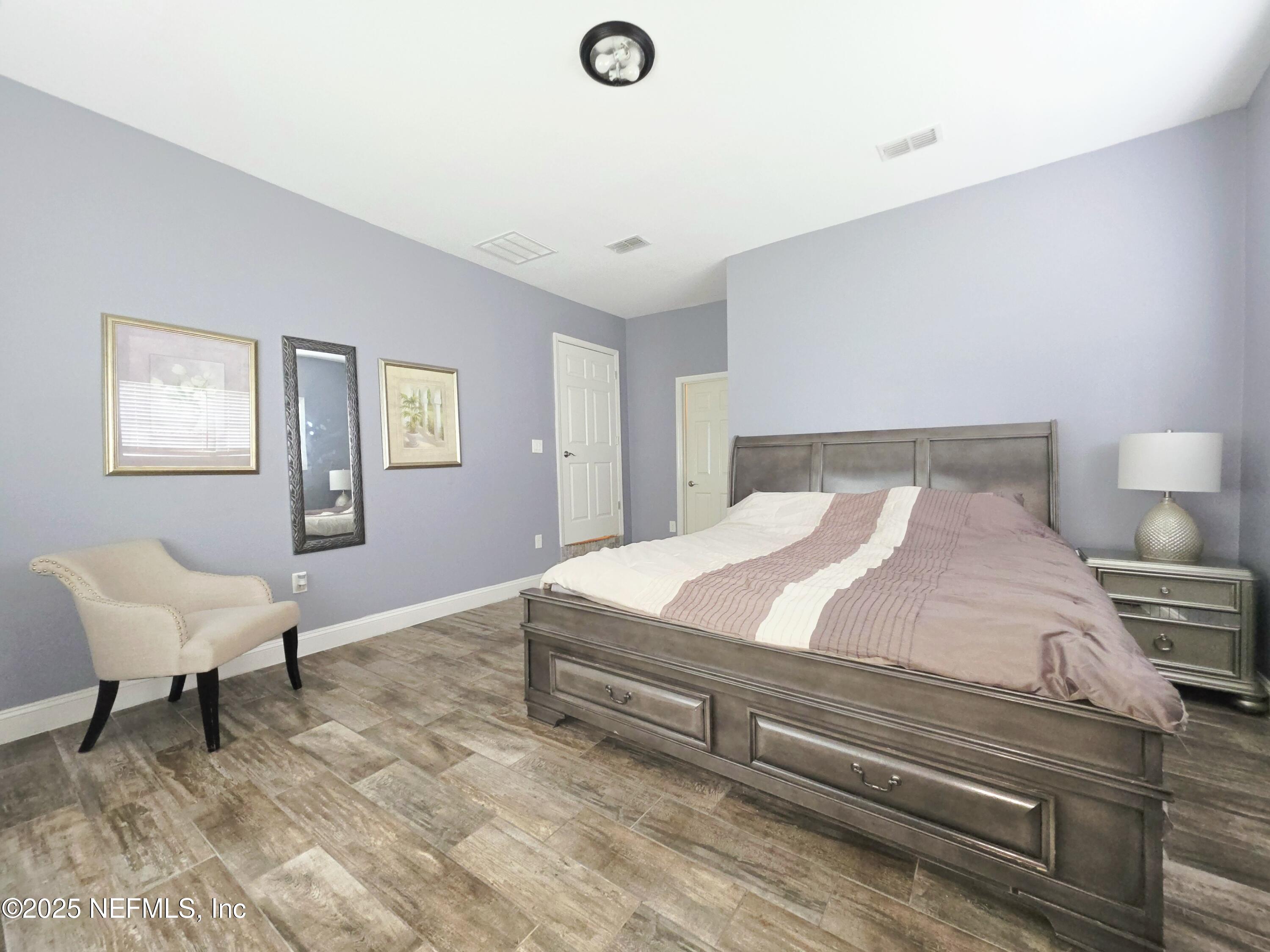 3065 Francis Road Jacksonville, FL 32209 - Photo 19 of 22 a bedroom with a bed and a chair